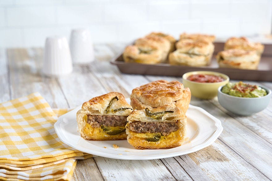 Multiple spicy sausage egg cheese bombs on serving trays