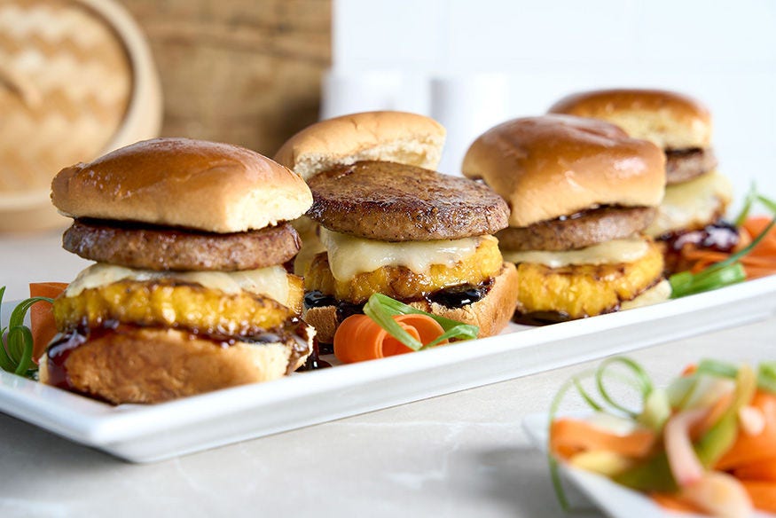 Four Asian sliders on a serving tray